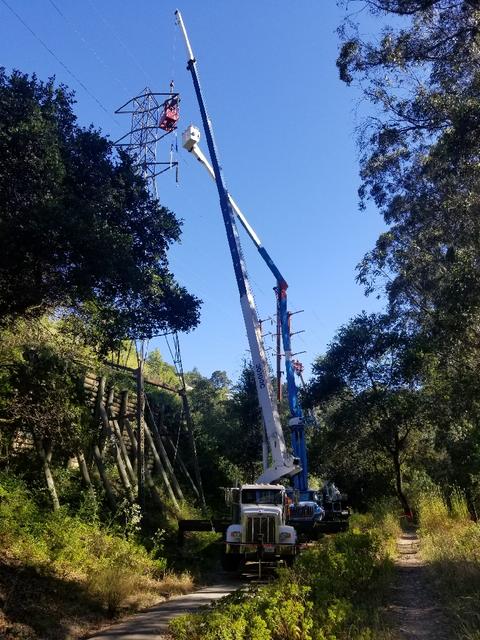 Our 30 ton boom truck with jib, lifting a man basket in Oakland, CA in coordination with utility cherry picker truck